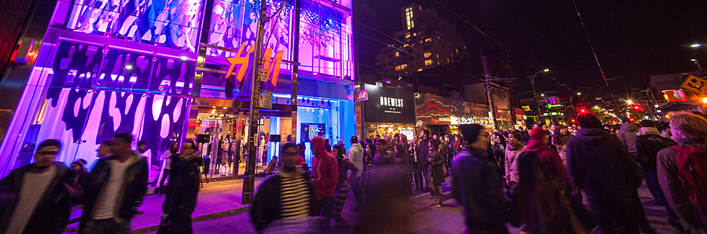 Artwork on H&M storefront at night