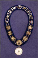 Mayoral Ceremonial Chain of Office, which includes, clockwise from top: the Shield of Canada on a gold medallion; two golden maple leaves and the Canadian Flag; the Civic Coat of Arms of the former City of York with a beaver on the left-hand side of the shield, a symbol of the city's history for industry and activity; the Civic Coat of Arms of the former City of Etobicoke featuring Etobicoke's symbol, an alder tree, in the centre of the shield; the Civic Shield of the former City of North York featuring North York's motto, "Progress With Economy"; the Civic Shield of the former Municipality of Metro Toronto featuring eagle wings in the top of the shield, a symbol of our city's native background; the Civic Coat of Arms of the former City of Toronto incorporated in 1834; the Civic Coat of Arms of the former City of Scarborough featuring Scarborough's symbol, the columbine flower, in the centre of the shield; the Civic Coat of Arms of the former Borough of East York formerly Canada's only Borough, featuring a Bulldog, East York's mascot; the Provincial Shield of Ontario and two golden maple leaves hanging from the bottom of the Chain of Office, and worn in front, is a golden medallion with the amalgamated City of Toronto's Coat of Arms.