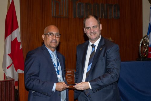 Dr. Akwatu Khenti, Inaugural Chair, Black Scientists' Task Force and City Manager Paul Johnson holding City Manager Award in Council Chamber