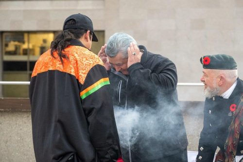 Gimaa Stacey Laforme is being smudged by Fire Keeper and Teacher Geoffrey Daybutch, while Vetreran Alan Roy watches
