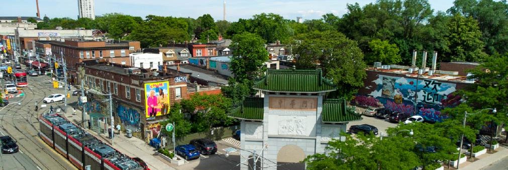 An aerial view of a Toronto neighbourhood with streetcars passing along the road.